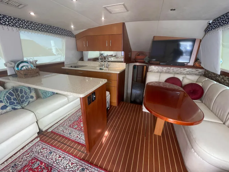 Slide: The Image of Luxurious interior of 2000 Ocean Yachts Convertible with modern kitchen and cozy seating area. - 7