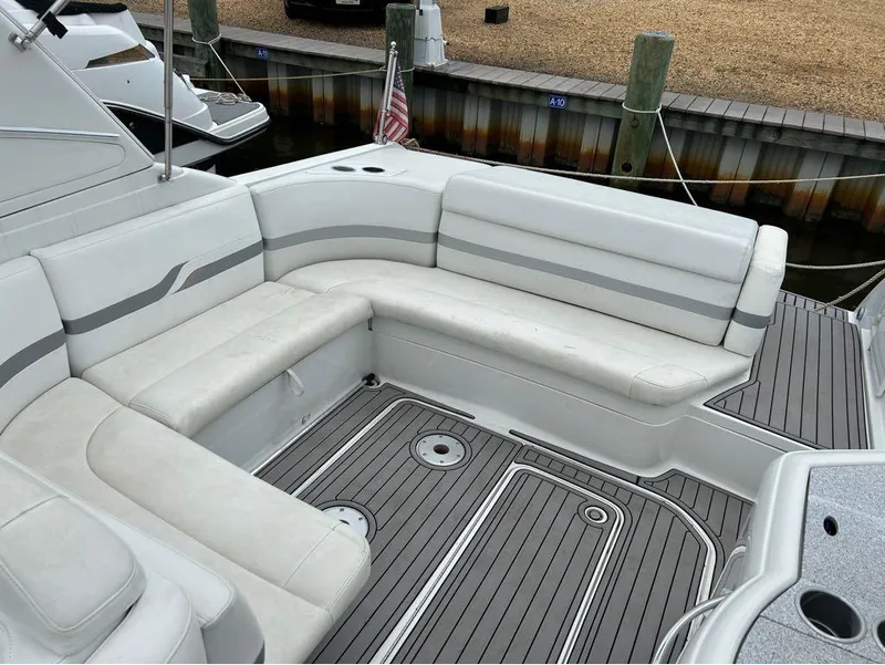 Slide: The Image of 2004 Formula 330 SS boat with white and gray seating, docked at marina. - 10