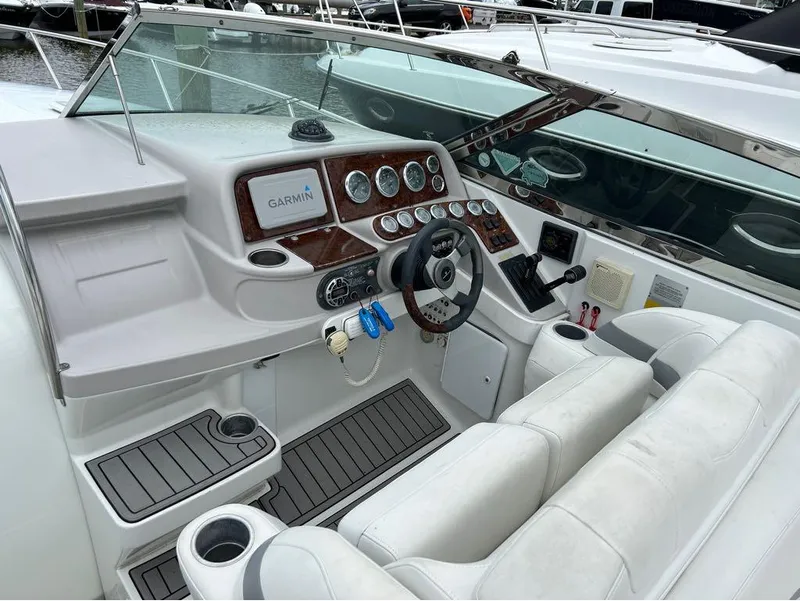 Slide: The Image of 2004 Formula 330 SS boat cockpit with Garmin navigation system and white leather seats. - 4