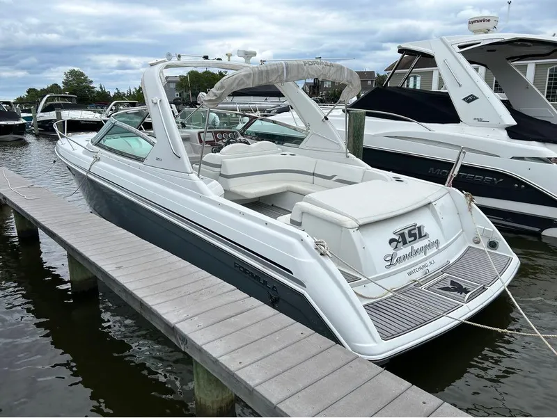 Slide: The Image of 2004 Formula 330 SS boat docked at marina, rear view. - 9