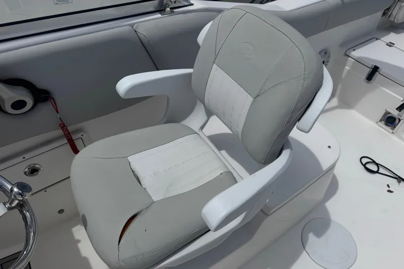 Slide: The Image of Captain's chair on 2020 Sea Fox 226 Traveler boat, featuring white and gray upholstery. - 15