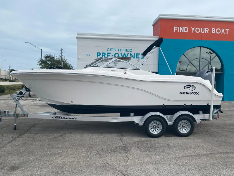 Slide: The Image of 2020 Sea Fox 226 Traveler boat on a trailer outside a dealership. - 2
