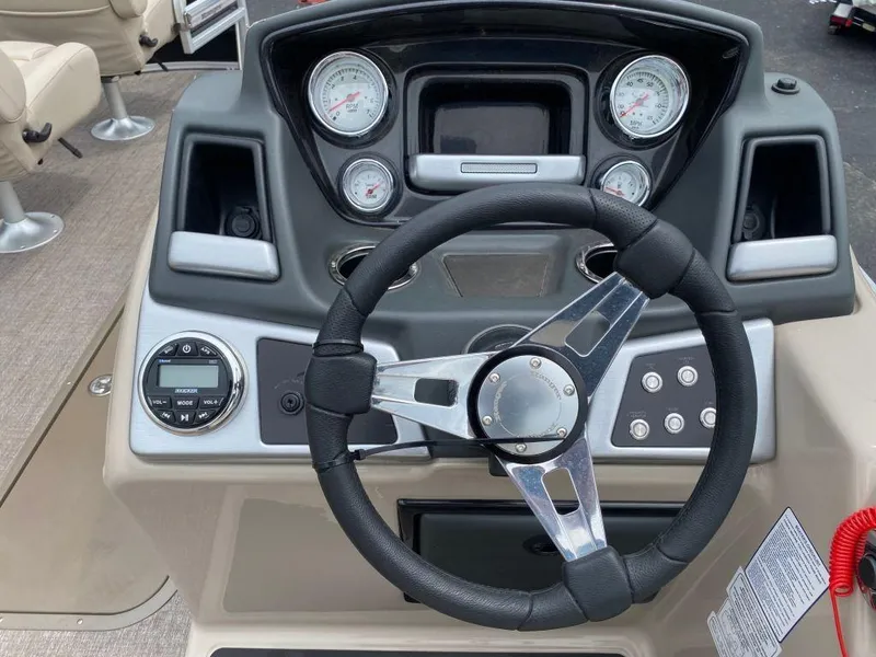 Slide: The Image of 2023 Ranger 223FC boat dashboard with steering wheel and control panel. - 1