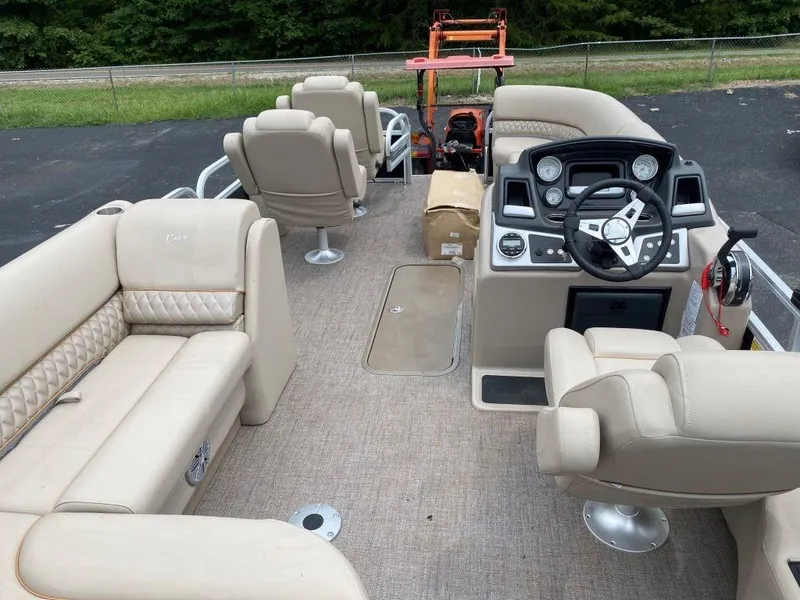 Slide: The Image of 2023 Ranger 223FC pontoon boat with beige interior and modern dashboard. - 3