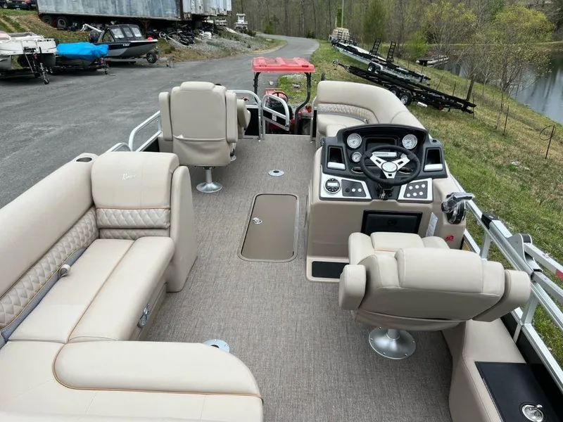 Slide: The Image of 2023 Ranger 223FC pontoon boat with beige interior and modern dashboard. - 4