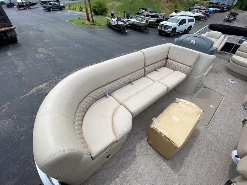 Slide: The Image of 2023 Ranger 223FC boat with beige seating and a cardboard box on the deck. - 5