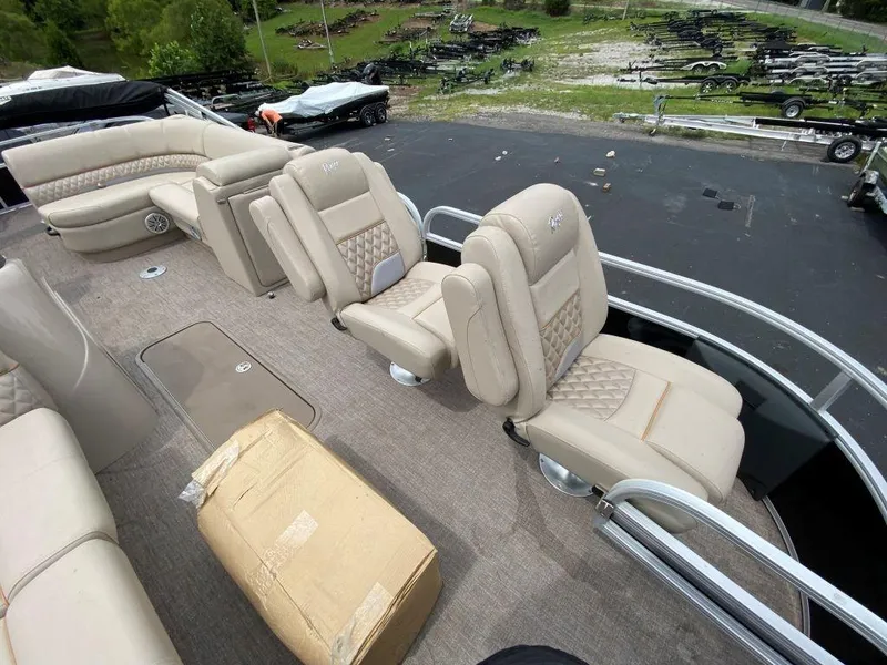 Slide: The Image of 2023 Ranger 223FC boat interior with beige seating and deck. - 6