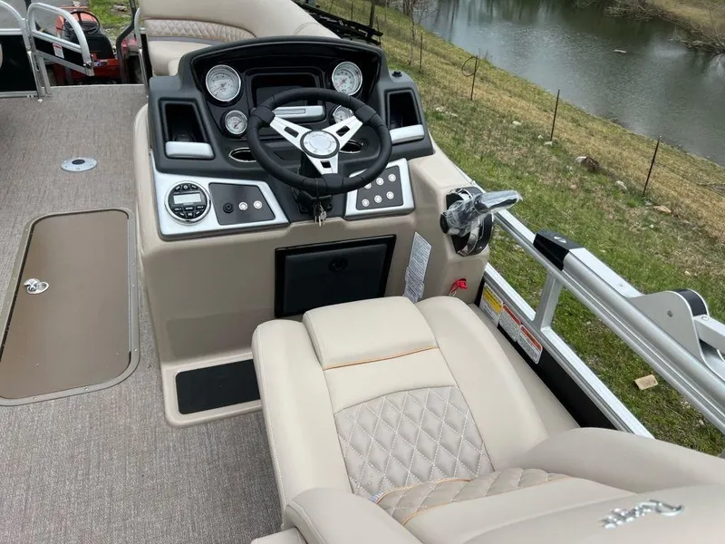Slide: The Image of 2023 Ranger 223FC boat cockpit with steering wheel and control panel. - 7