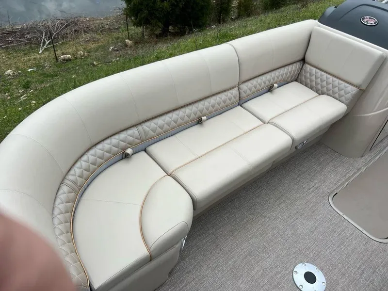 Slide: The Image of 2023 Ranger 223FC boat with beige cushioned seating and diamond-stitched accents. - 9