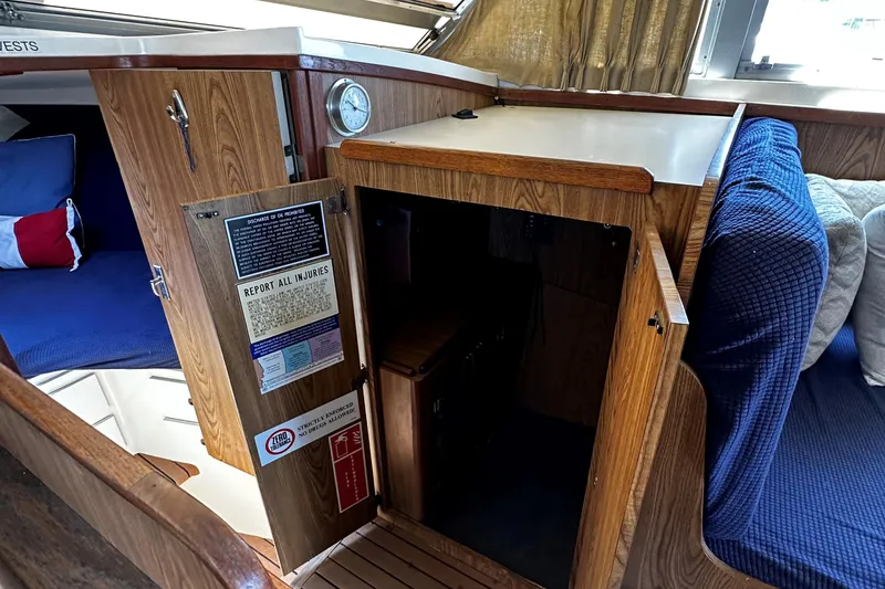 Slide: The Image of Interior cabin of a 1980 Bertram 33 Sport Fisherman boat with wooden cabinetry. - 11