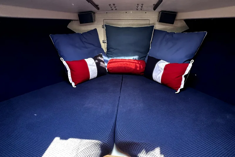 Slide: The Image of Cozy cabin interior of 1980 Bertram 33 Sport Fisherman with blue and red pillows. - 2