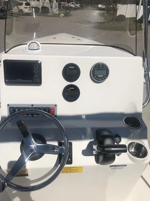 Slide: The Image of 2024 Key West 189 FS boat dashboard with steering wheel and gauges. - 11