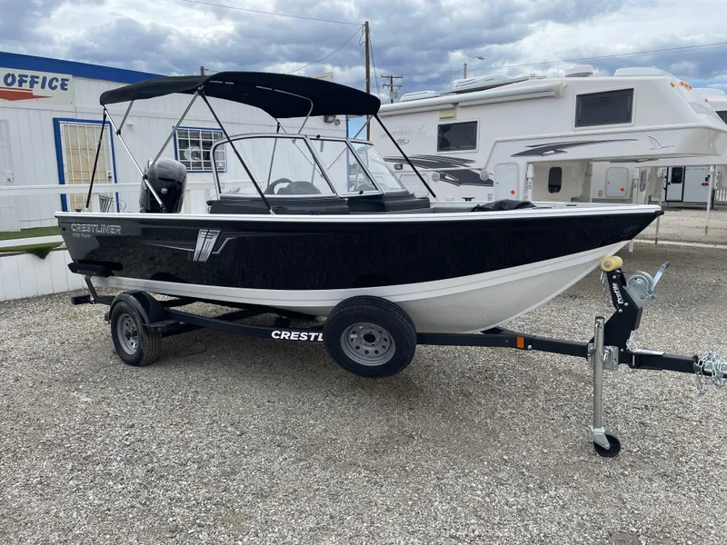 Slide: The Image of 2022 Crestliner 1700 Vision boat on trailer, parked outdoors. - 1