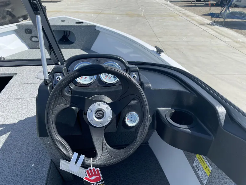Slide: The Image of 2022 Crestliner 1700 Vision boat dashboard with steering wheel and gauges. - 13