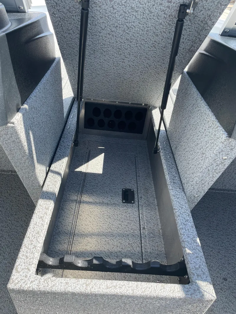 Slide: The Image of 2022 Crestliner 1700 Vision boat storage compartment with rod holders. - 16