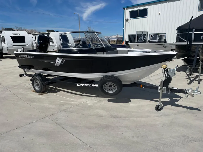 Slide: The Image of 2022 Crestliner 1700 Vision boat on trailer outside dealership. - 2