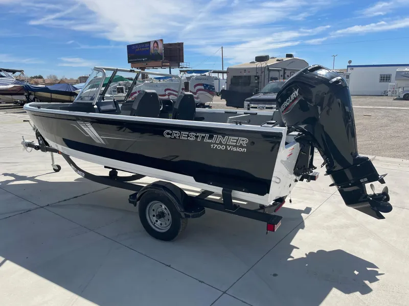 Slide: The Image of 2022 Crestliner 1700 Vision boat on a trailer with a Suzuki outboard motor. - 4