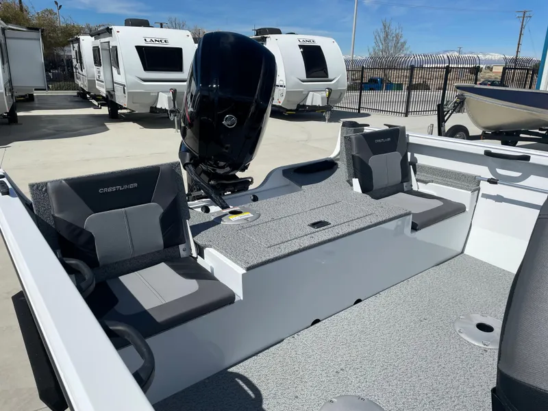 Slide: The Image of 2022 Crestliner 1700 Vision boat interior with motor, parked near RVs. - 8
