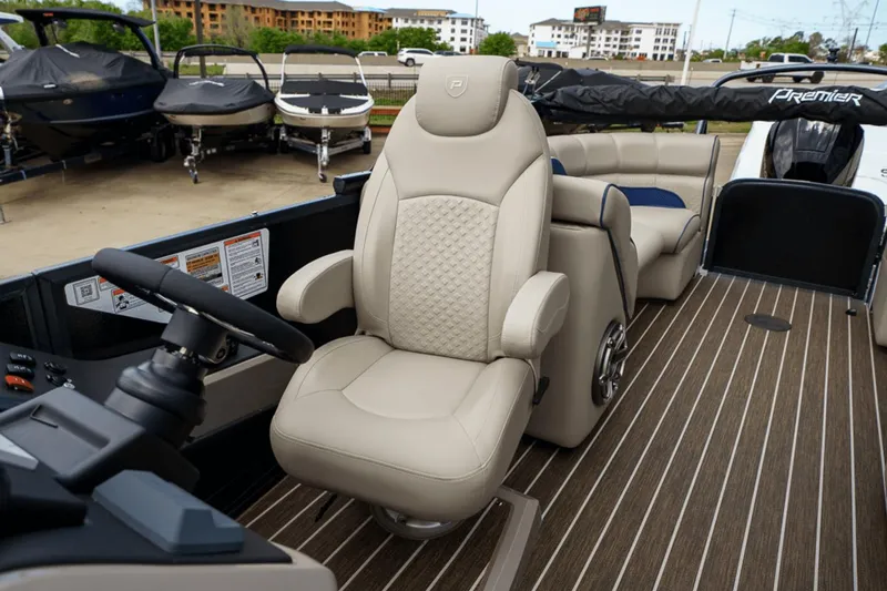 Slide: The Image of 2023 Premier 230 Solaris boat interior with luxurious captain's chair and sleek design. - 24