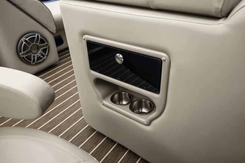 Slide: The Image of 2023 Premier 230 Solaris interior with cup holders and speaker on striped flooring. - 32