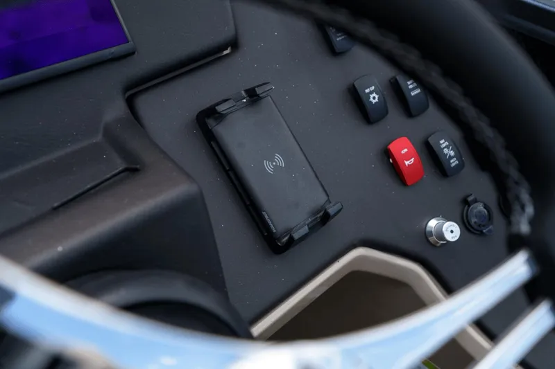 Slide: The Image of Control panel of 2023 Premier 230 Solaris boat with wireless charging pad and buttons. - 21