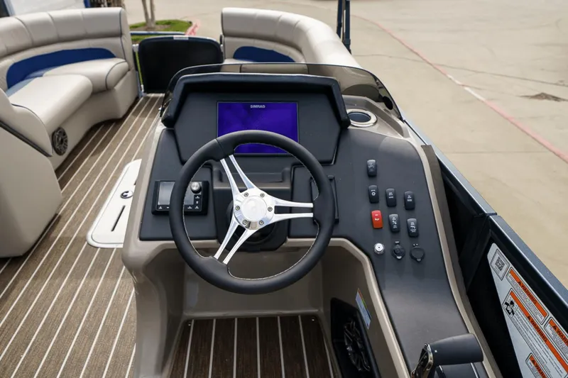 Slide: The Image of 2023 Premier 230 Solaris boat dashboard with steering wheel and control panel. - 18