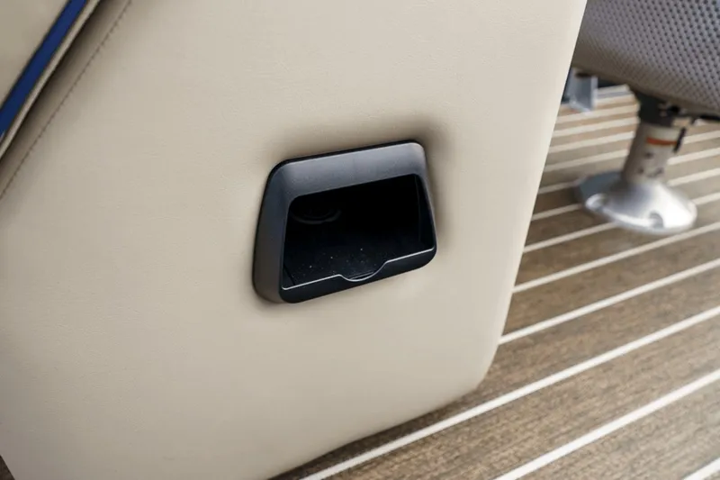 Slide: The Image of Cup holder on 2023 Premier 230 Solaris boat with beige upholstery and striped flooring. - 31