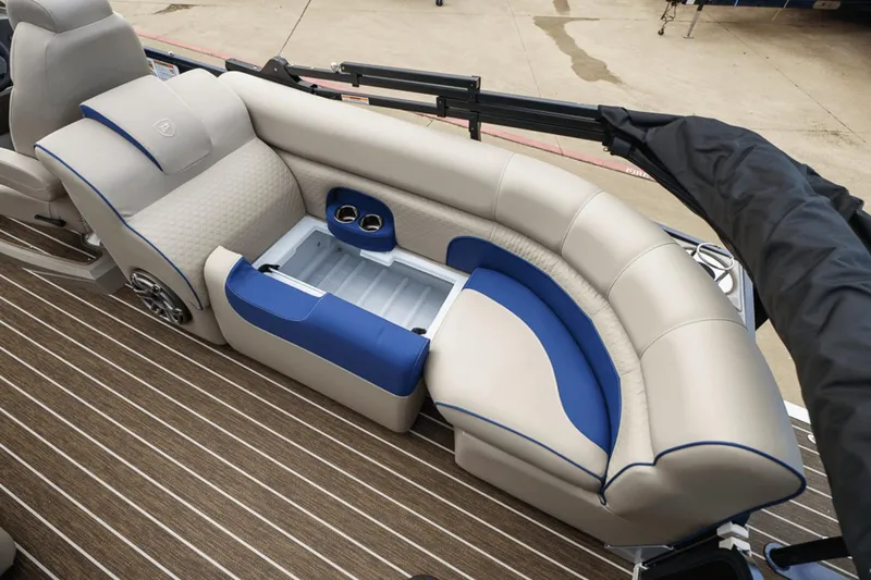 Slide: The Image of 2023 Premier 230 Solaris boat interior with beige and blue seating, featuring storage compartment. - 34