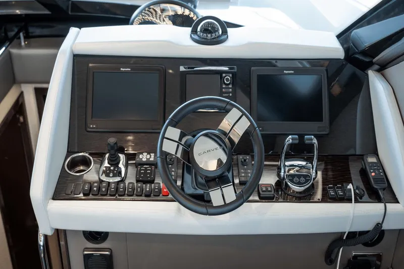 Slide: The Image of 2017 Carver 52 Command Bridge helm with modern controls and dual displays. - 17