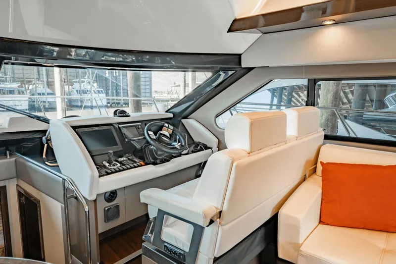 Slide: The Image of Interior of 2017 Carver 52 Command Bridge yacht with modern helm and white seating. - 27