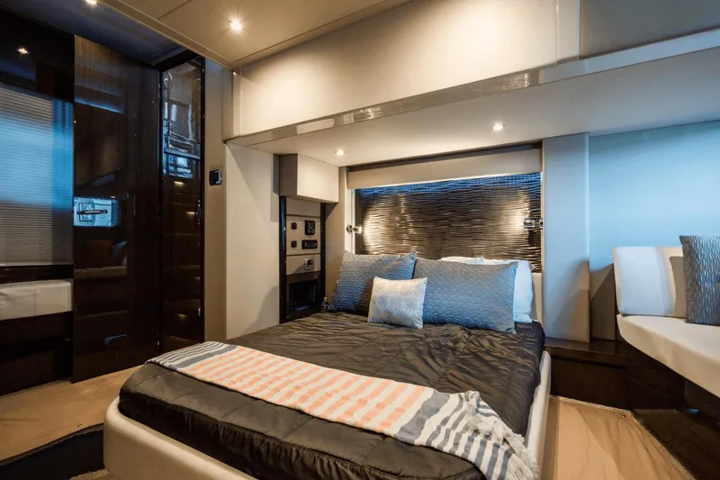 Slide: The Image of Luxurious bedroom interior of 2017 Carver 52 Command Bridge yacht, featuring modern design and cozy bedding. - 44