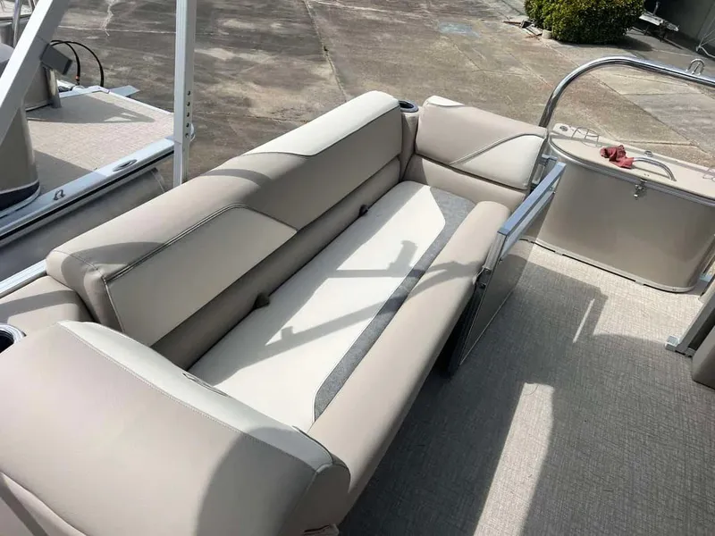 Slide: The Image of 2023 Avalon 2380 Venture Quad Lounger boat interior with beige seating. - 11