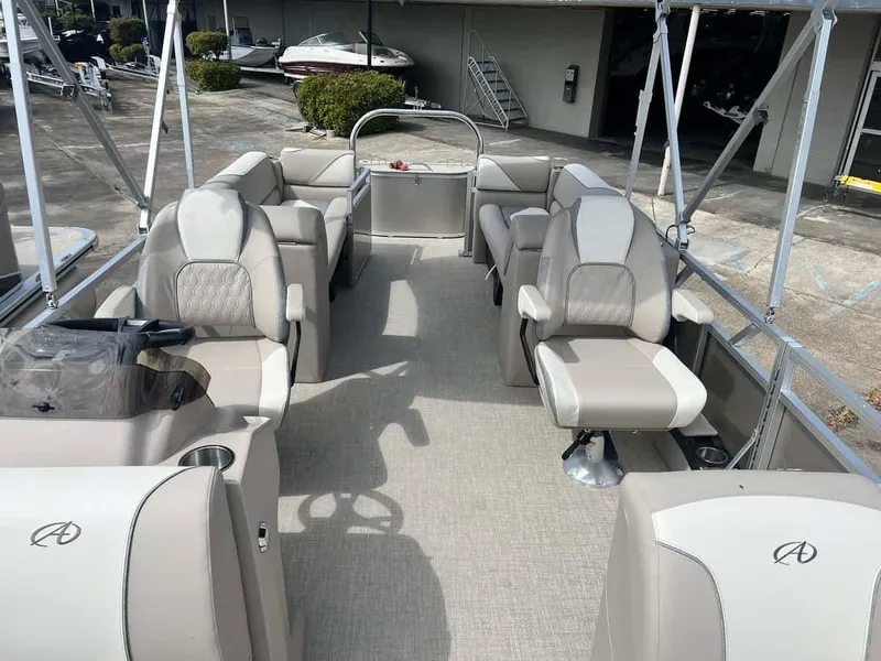 Slide: The Image of 2023 Avalon 2380 Venture Quad Lounger pontoon boat interior with beige seating. - 7