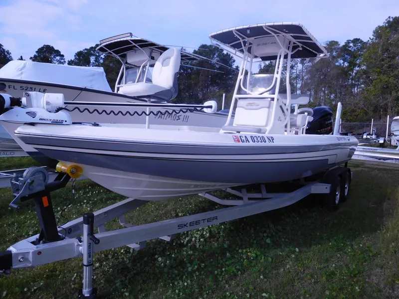 The Image of 2015 Skeeter SX 240 boat on trailer in outdoor storage area. - 1