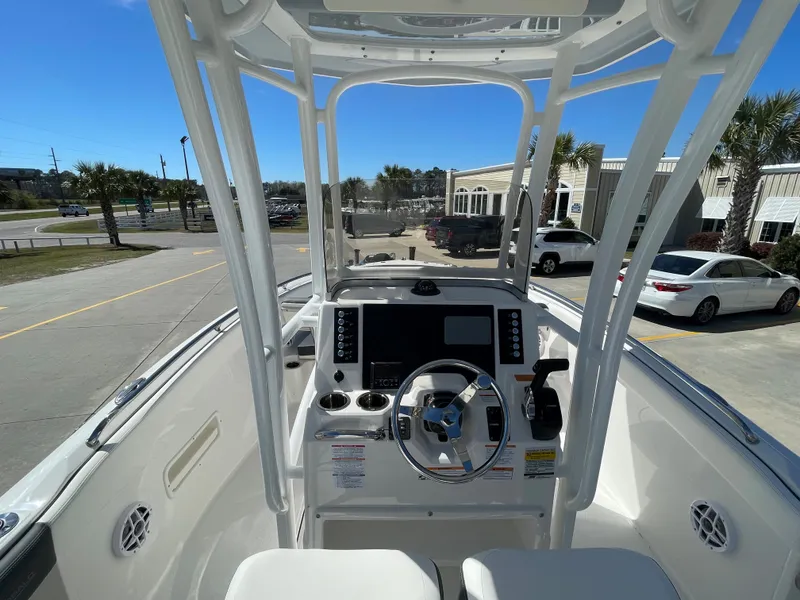 Slide: The Image of 2024 Robalo R222 Center Console boat interior with steering wheel and control panel. - 10