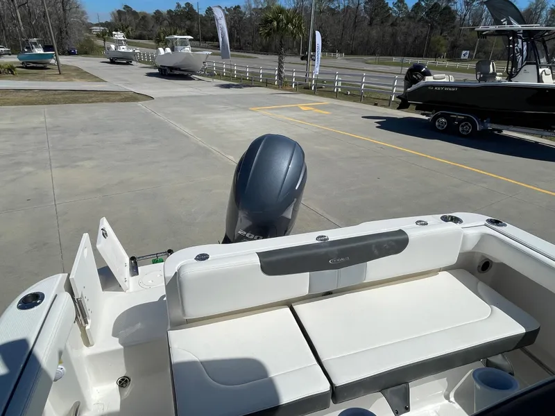 Slide: The Image of 2024 Robalo R222 Center Console boat with outboard motor in a marina. - 5
