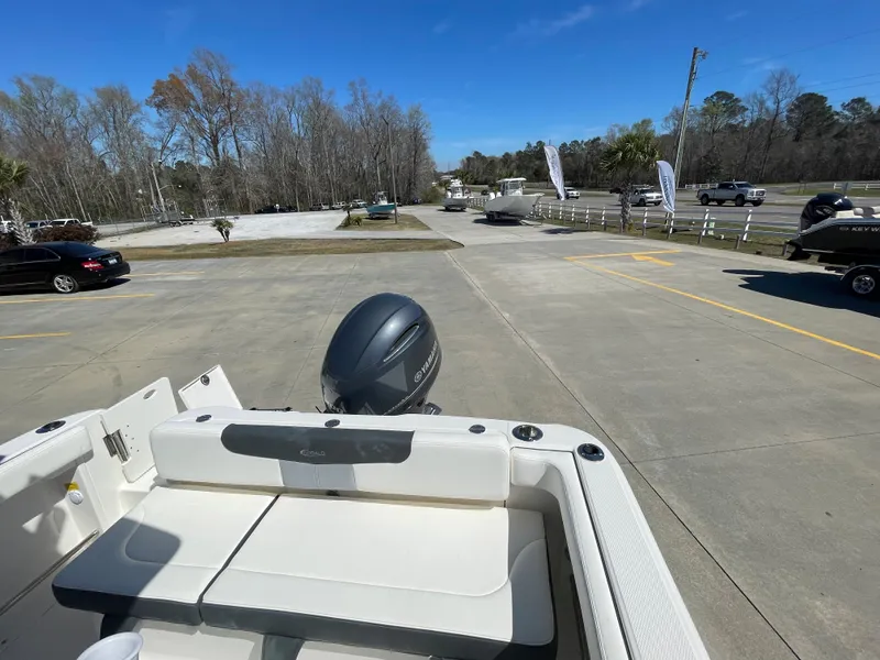 Slide: The Image of 2024 Robalo R222 Center Console boat in a parking lot. - 9