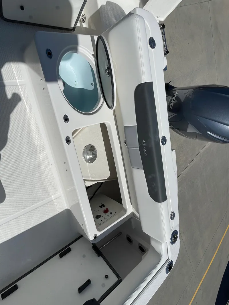 Slide: The Image of 2024 Robalo R222 Explorer boat deck with storage compartments and engine. - 14