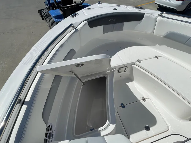 Slide: The Image of 2024 Robalo R222 Explorer boat with open storage compartment. - 17