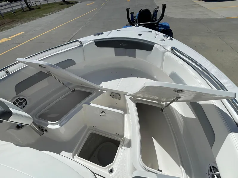 Slide: The Image of 2024 Robalo R222 Explorer boat with open storage compartments. - 18