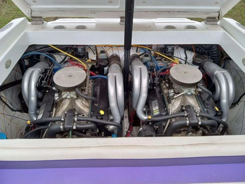Slide: The Image of Twin engines in a 1999 Baja 33 Outlaw boat, showcasing powerful performance. - 13