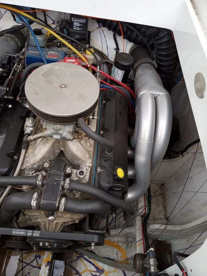 Slide: The Image of Engine compartment of a 1999 Baja 33 Outlaw boat, showcasing mechanical components. - 14