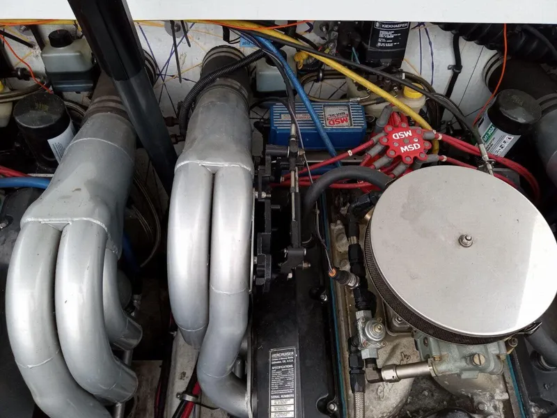 Slide: The Image of Engine compartment of a 1999 Baja 33 Outlaw boat, featuring visible wiring and components. - 15