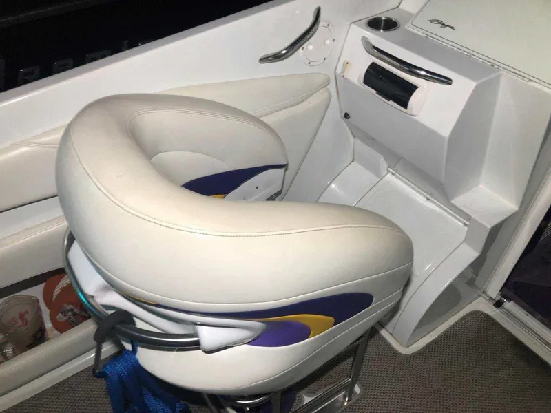 Slide: The Image of 1999 Baja 33 Outlaw boat interior with white and purple seating. - 22