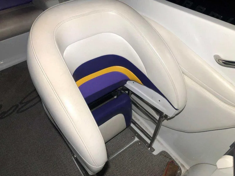 Slide: The Image of 1999 Baja 33 Outlaw boat seat with white, purple, and yellow upholstery. - 24