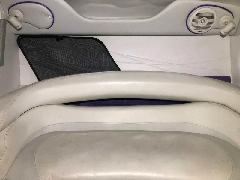 Slide: The Image of 1999 Baja 33 Outlaw interior with white seating and speaker details. - 26