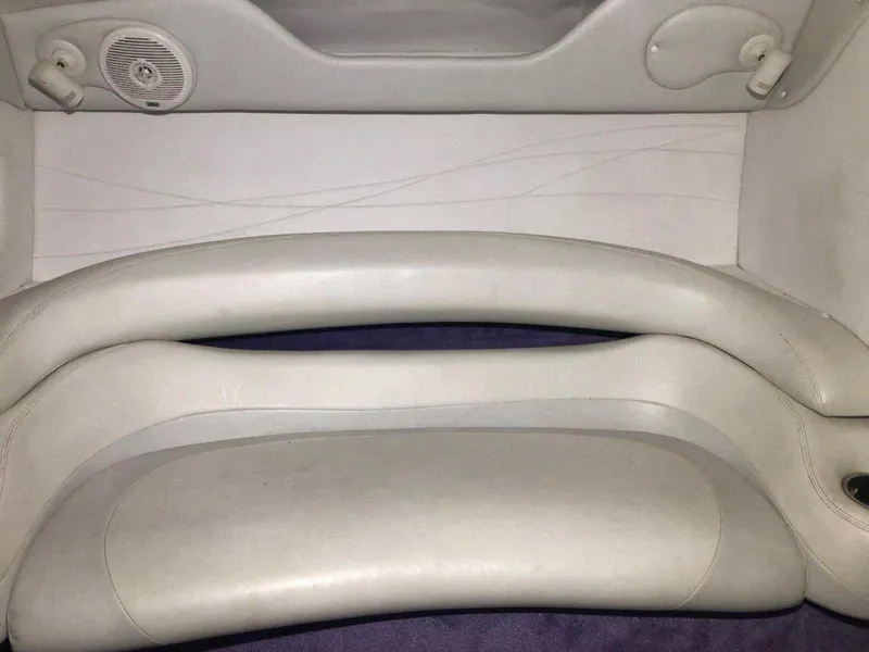 Slide: The Image of 1999 Baja 33 Outlaw boat interior with white leather seating and speaker. - 27