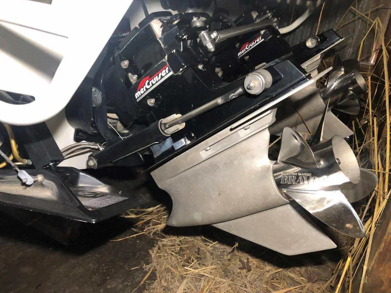 Slide: The Image of 1999 Baja 33 Outlaw boat with MerCruiser Bravo engine and propeller in close-up view. - 32