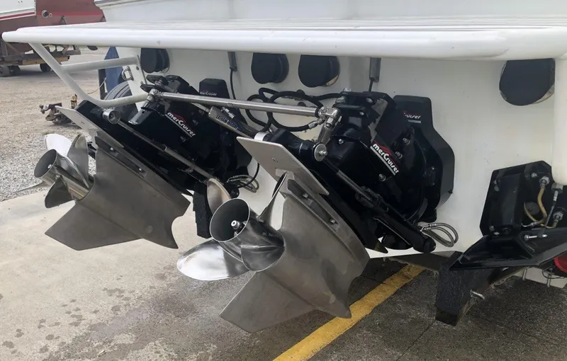 Slide: The Image of 1999 Baja 33 Outlaw boat with dual MerCruiser outdrives and stainless steel propellers. - 37