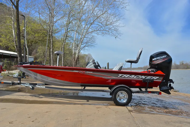 Slide: The Image of 2017 Tracker Pro Team 175 TXW fishing boat on trailer by a lake. - 11